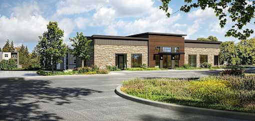 A modern building with a parking lot in front.