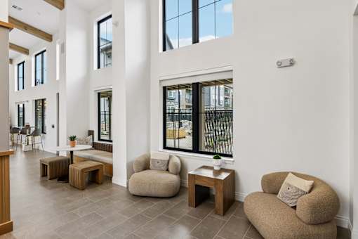 A white room with a large window and a couch.