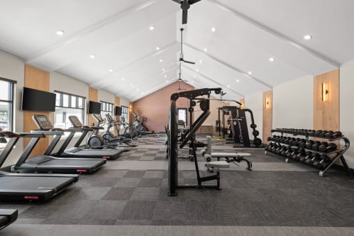 a gym filled with cardio equipment and weights at Notch66, Longmont, Colorado