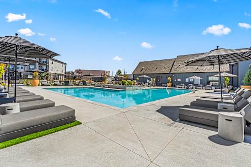 A large outdoor swimming pool with steps leading down to the water.