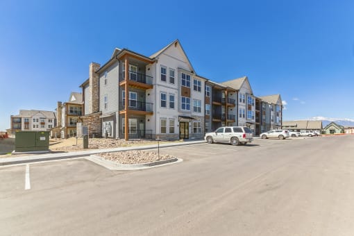 a large building with a parking lot in front of it  at Upland Flats, Colorado Springs, Colorado