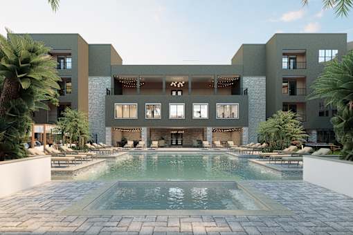 A modern building with a pool in front at Refinery at Pointe17 Apartments, Arizona
