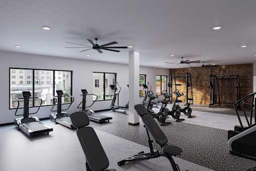 A gym with a variety of equipment including treadmills, stationary bikes, and weight machines at Refinery at Pointe17 Apartments, Phoenix, AZ