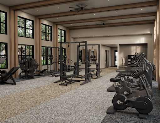 A gym with a variety of equipment including treadmills, weights, and exercise machines.