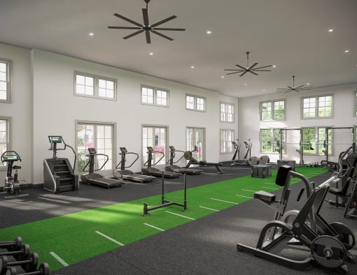 a gym with treadmills and other exercise equipment and windows at The Hadley Luxury Apartments, Florida, 34287