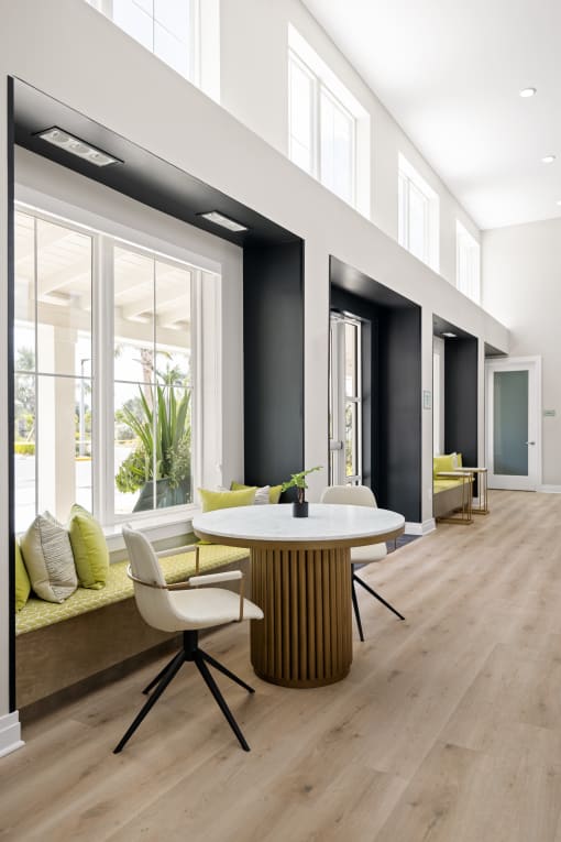 a dining room with a table and chairs in front of a large window at Palm Grove in Ellenton, FL 34222