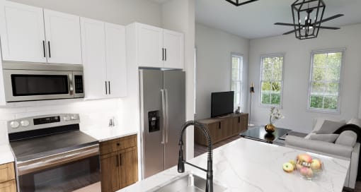 a kitchen and living room with white cabinets and stainless steel appliances at The Hadley Luxury Apartments, North Port, FL