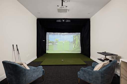 A room with a screen and two chairs.
