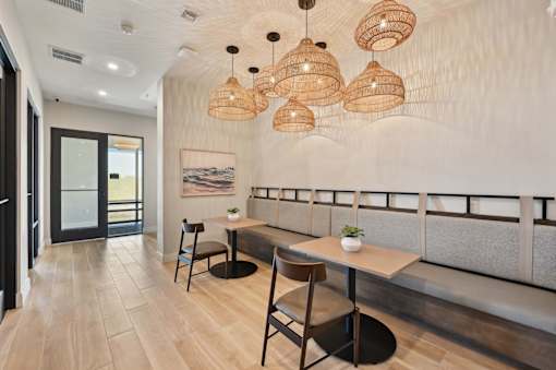 A modern dining area with a wooden table and chairs.