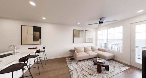 A modern living room with a white kitchen area and a large window.