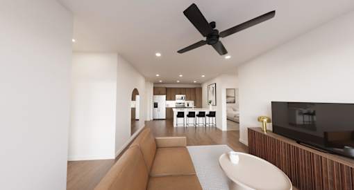 A modern living room with a brown sofa and a white ceiling fan.