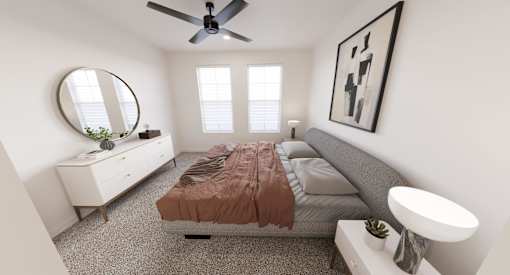 A bedroom with a bed, a dresser, a mirror, and a ceiling fan.