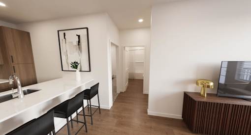 A modern kitchen with a white countertop and black chairs.