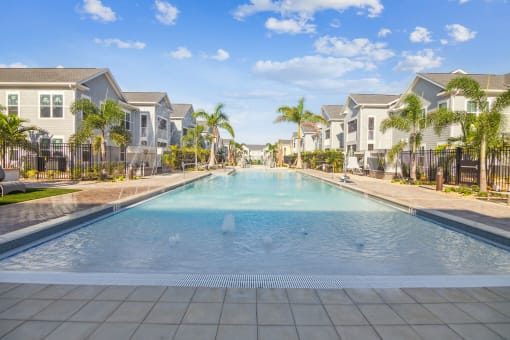 a large swimming pool with houses in the background  at Palm Grove, Florida