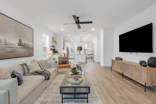 a living room with a couch and a tv at Meridian at CityPlace, Woodbury