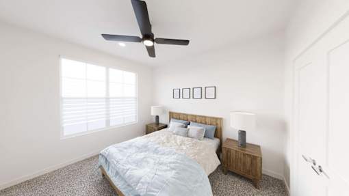 A bedroom with a bed, nightstand, and a ceiling fan.
