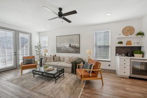 a living room with a couch and a ceiling fan