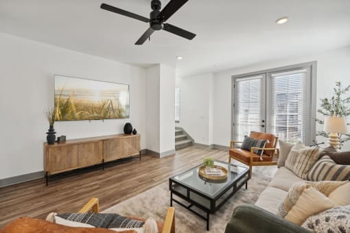 a living room with a ceiling fan and a couch at Meridian at CityPlace, Woodbury, MN 55125