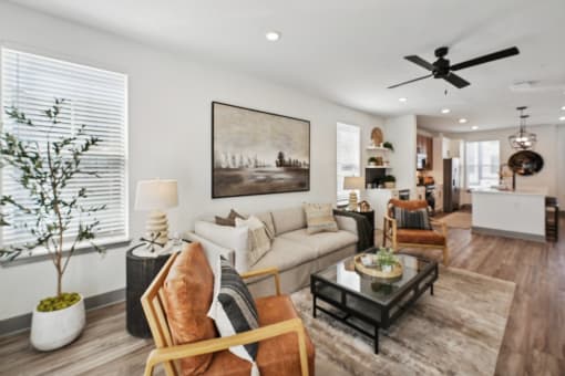 a living room with a ceiling fan and a couch at Meridian at CityPlace, Woodbury, Minnesota