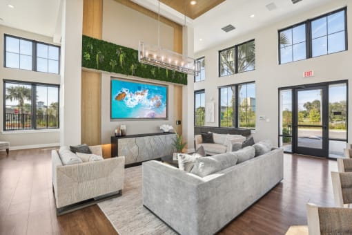 a living room with couches and a tv on the wall at Drift, Daytona Beach, FL, 32117