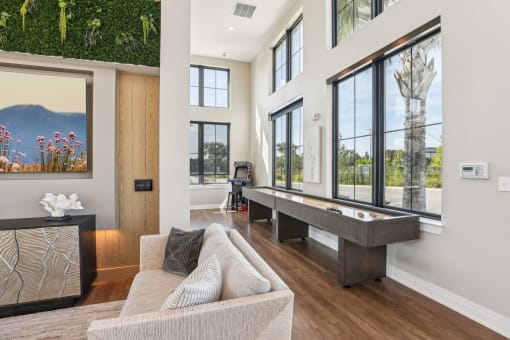 living room with a couch and a pool table at Drift, Daytona Beach, FL, 32117