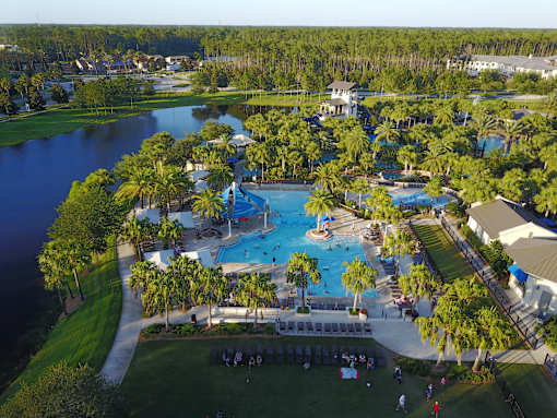 Resort style pool with water slides and palm trees at Velara Luxury Apartments, Ponte Vedra Beach, FL 32081