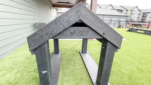 a dog house with a sign that says dogs only at The Depot, Raymore, MO