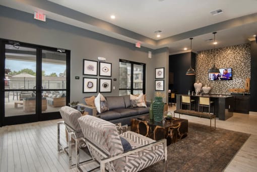 a living room with a couch and chairs and a tv at Watermark at Steele Crossing, Arkansas, 72703