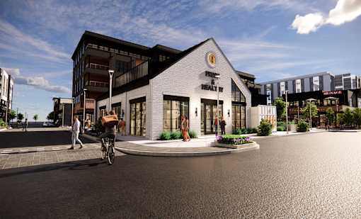 A modern building with a bicycle rider in front of it at The Union Flats at Fishers District, Fishers 46037