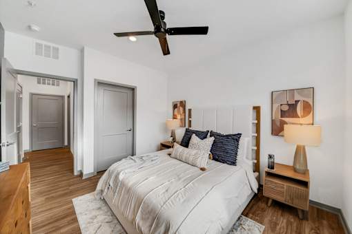 A bedroom with a bed, nightstand at The Levi Luxury Apartments, McDonough, Georgia