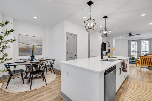 an open kitchen and dining area with a table and chairs at Meridian at CityPlace, Minnesota