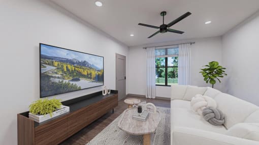 a living room with a large tv and a white couch  at Alta25, Monument, CO