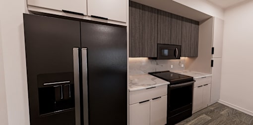 A black refrigerator is in a kitchen with white countertops at Verity Luxury Apartment Homes Apartments, Vero Beach, FL 32960