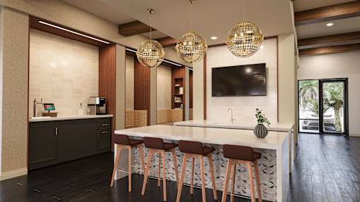A modern kitchen with a bar area and a television mounted on the wall at The Stadler Luxury Apartments, Florida