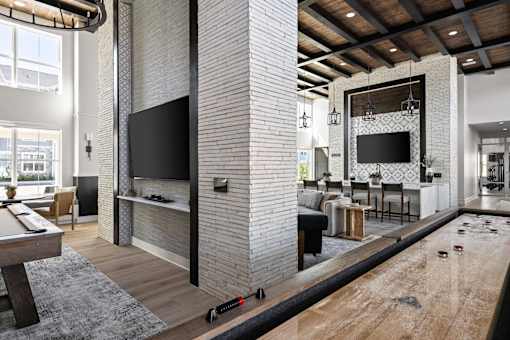 A room with a pool table and a television.
