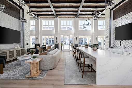 A modern open plan living and kitchen area with a long white marble island.