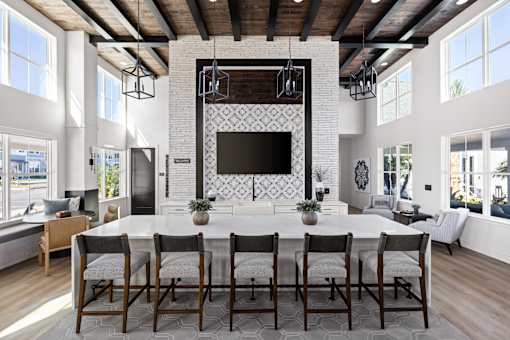 A modern dining room with a large table and chairs.