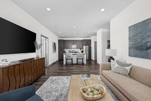 A modern living room with a wooden coffee table and a large couch.