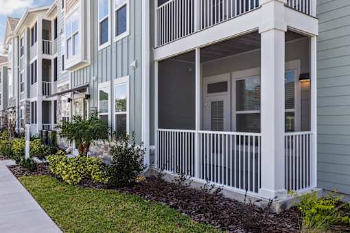 A row of townhouses with white railings and balconies.