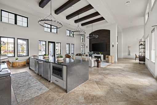 A modern kitchen with a large island and a fireplace. at Terrassa Luxury Apartments, Florida, 32084
