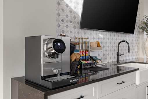 A Nespresso coffee machine sits on a countertop in a kitchen. at Terrassa Luxury Apartments, Florida, 32084