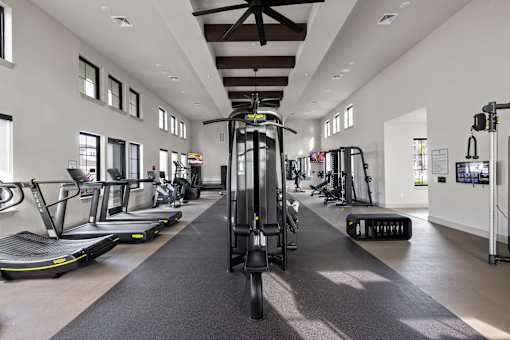 A gym with treadmills, elliptical machines and other exercise equipment. at Terrassa Luxury Apartments, St. Augustine