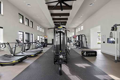 A gym with treadmills, elliptical machines, and other exercise equipment. at Terrassa Luxury Apartments, Florida
