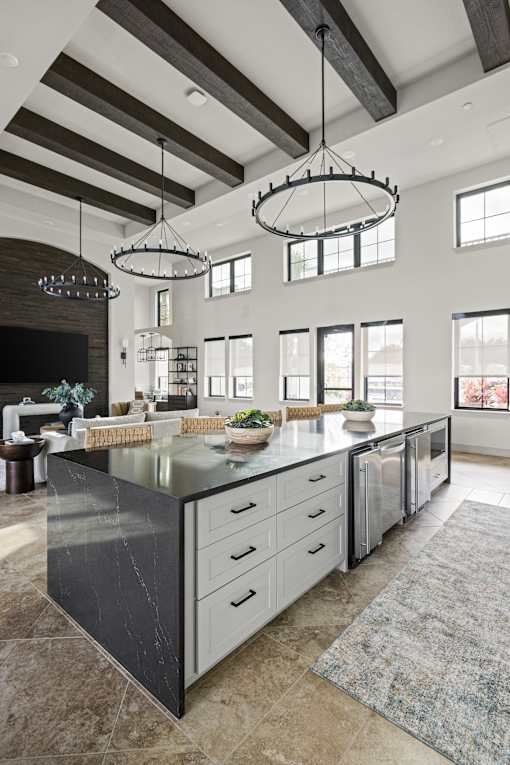 A modern kitchen with a large island and pendant lights. at Terrassa Luxury Apartments, St. Augustine, Florida