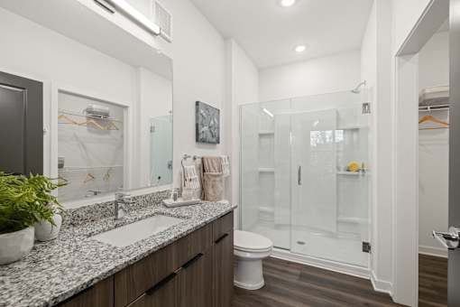 A bathroom with a sink, toilet, and shower. at Terrassa Luxury Apartments, Florida, 32084