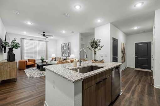 A modern kitchen with a large island and wooden floors. at Terrassa Luxury Apartments, Florida, 32084