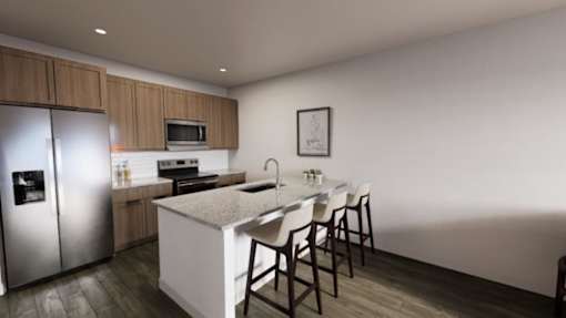 A modern kitchen with a refrigerator, microwave, oven, sink, and a dining table with chairs.