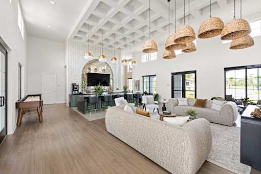 A modern living room with a large sectional sofa and a wooden floor.