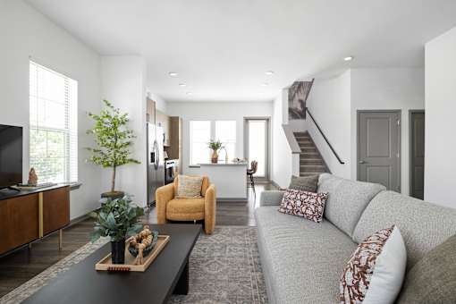 A living room with a grey couch and a coffee table.