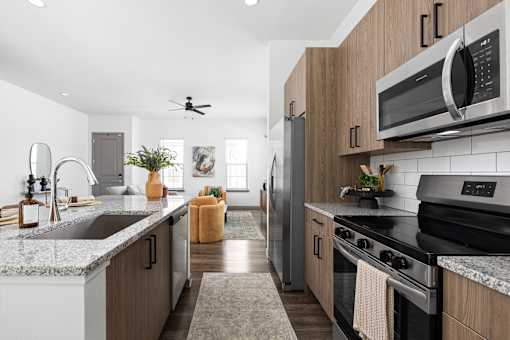 A modern kitchen with wooden cabinets and stainless steel appliances.